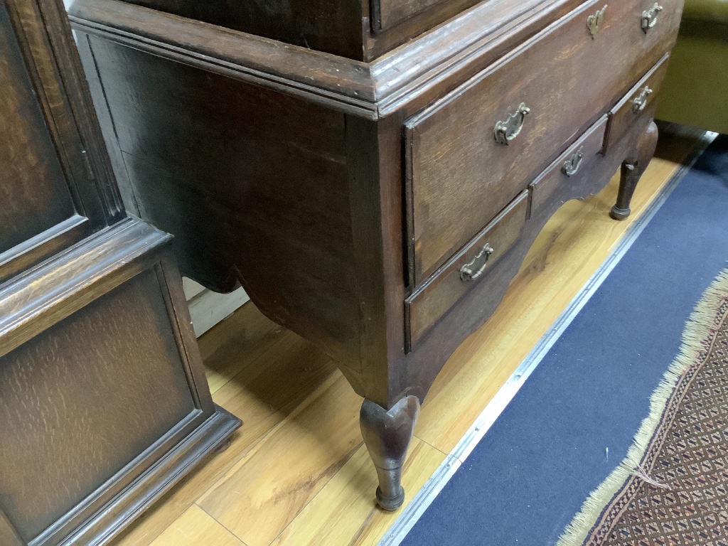 An 18th century cross banded oak chest on stand, width 116cm, depth 57cm, height 170cm